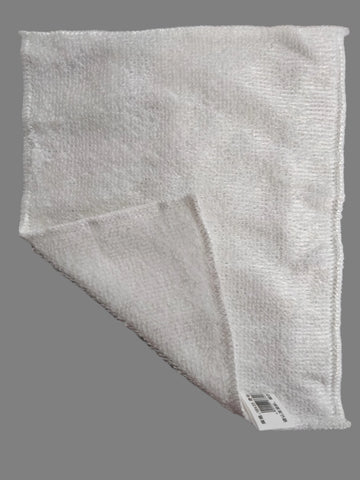 White fabric with a label on a speckled gray surface